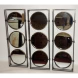 Three contemporary wall mirrors, each having rectangular frame with three circular mirrors, 31 x