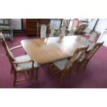 An Ercol dining table with two extra leaves, H.74 W.250 D.101cm, together with 6 matching dining