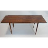 A mid 20th century Danish exotic hardwood drop leaf table, with sliding top raised on tapered