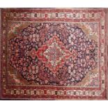 A north west Persian Sarouk rug the central double pendant medallion within repeating petal