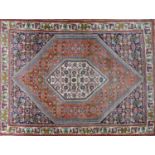 A fine Bidjar rug with geometric floral motifs within double diamond medallion, on a red,blue and