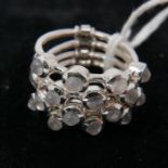 A sterling silver 4-row stack ring set with 16 round cabochon moonstones, Size: Q, 10.2g.