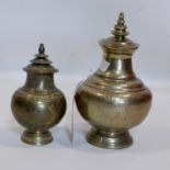 Two Islamic brass vases and covers, with stylised floral decoration, on stepped circular bases, H.