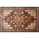 A North West Persian Nahavand rug the central diamond medallion with repeating petal motifs, on a