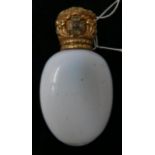 A 19th century scent bottle with opaline glass body with hinged yellow metal repousse mount inset