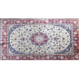 A 20th century Isfahan carpet with central floral medallion surrounded by floral motifs, on a