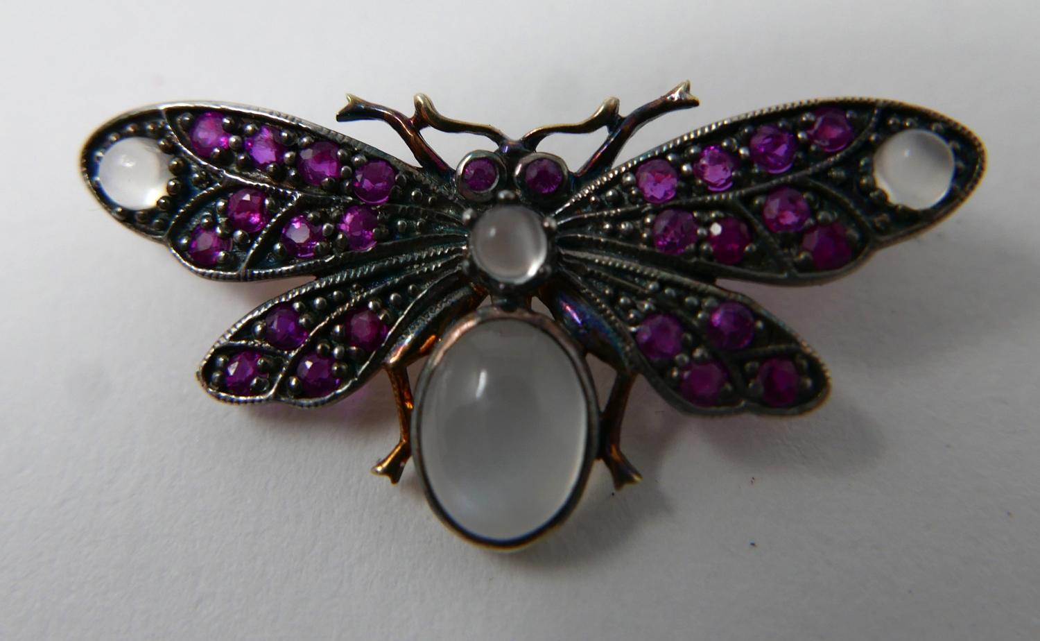 A yellow gold butterfly brooch studded with rubies and four moonstone cabochons, 1.5 x 3.5cm, 3.4g - Image 2 of 3