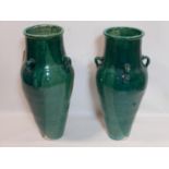 A pair of Persian green glazed Sharab wine vessels, H.90cm