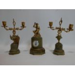 A French gilt metal and onyx clock and garniture set