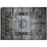 A Kashan style carpet with central floral medallion, on a beige ground, contained by floral borders,