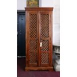A teak hall cupboard with two doors enclosing shelf space and three drawers, H.180 W.80 D.46cm