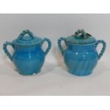 A pair of Persian cyan glazed jars and covers, with rope twist design handles, H.26 W.28cm