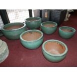 Two sets of three graduating teal glazed pots, H.23cm Diameter 42cm (largest)