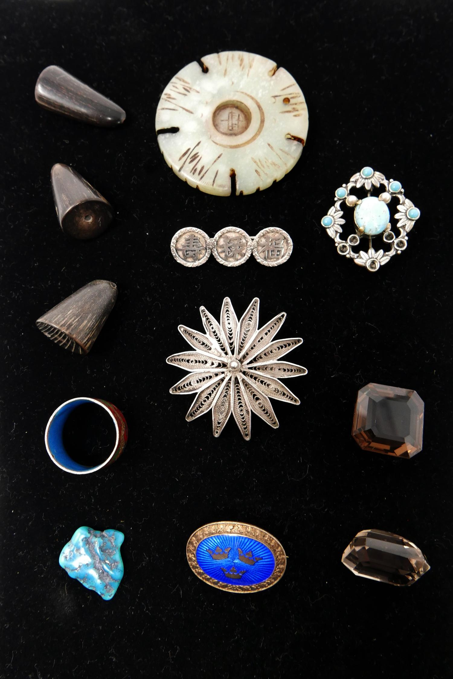 A small black box containing antique and vintage silver items to include a filigree brooch, a blue