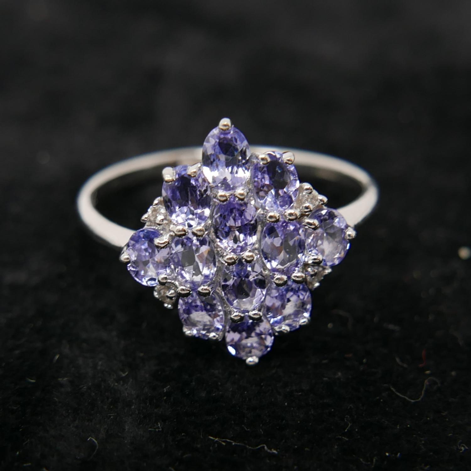 A boxed 9ct white gold marquise-shaped ring set with diamonds and tanzantites, Size: W 1/2, 3g.