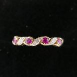 A boxed 9ct yellow gold ring set with 4 round faceted rubies inter-spaced by diamonds, Size: K 1/