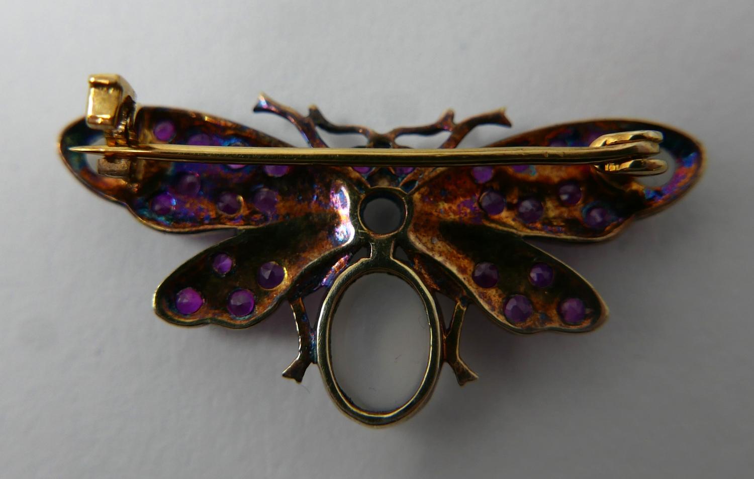 A yellow gold butterfly brooch studded with rubies and four moonstone cabochons, 1.5 x 3.5cm, 3.4g - Image 3 of 3