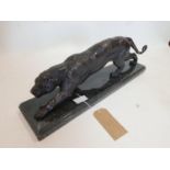 A cast bronze jaguar, raised on stepped rectangular marble base, H.23 W.66 D.15cm