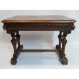 A Victorian Gothic revival oak side table, single drawer, carved with lion heads, raised on baluster