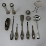 A collection of antique silver items to include a ladle, 18cm, a Victorian nail buffer, silver-