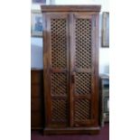 A teak hall cupboard with two doors enclosing shelf space and three drawers, H.180 W.80 D.46cm