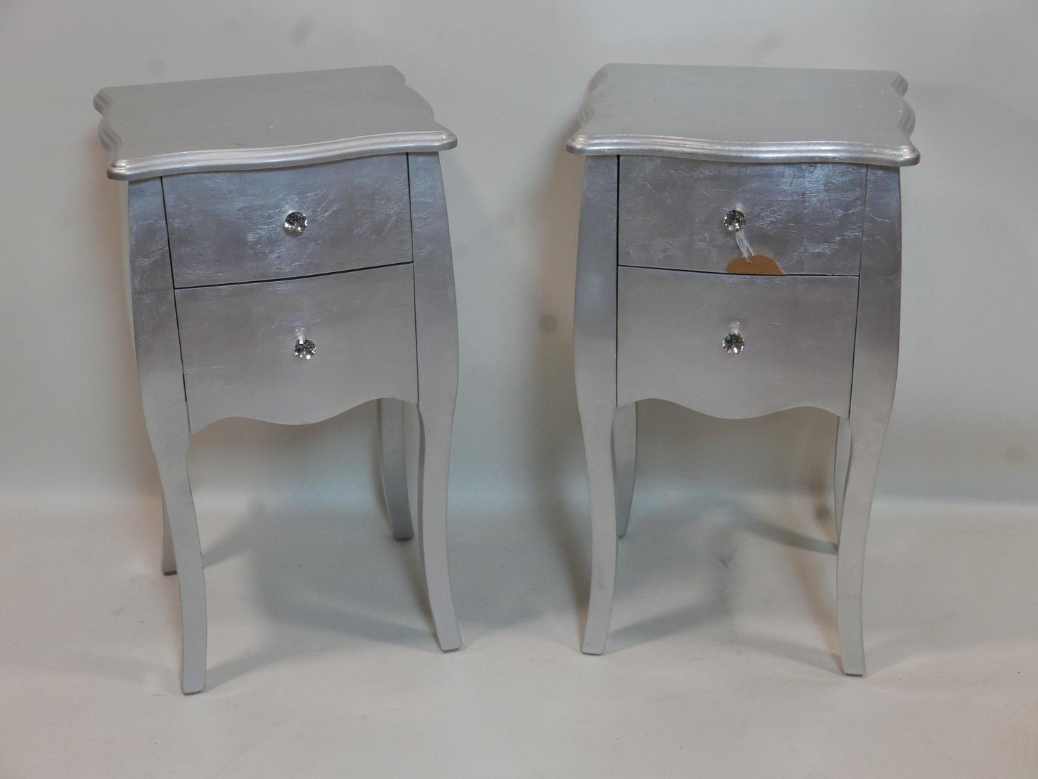 A pair of silvered bedside cabinets, two small drawers, on cabriole legs, H.71 W.40 D.35cm