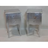 A pair of silvered bedside cabinets, two small drawers, on cabriole legs, H.71 W.40 D.35cm