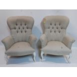 A pair of Victorian style spoon back armchairs with button back upholstery