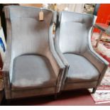 A pair of grey velour wing back armchairs, on square tapered legs