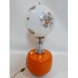 A vintage orange ceramic table lamp with chrome fitting and glroal glass shade, H.74cm