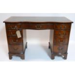 A Georgian style mahogany kneehole desk, with 9 drawers, raised on bracket feet, H.76 W.115 D.53cm