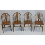 A set of four elm Ercol chairs