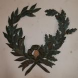 A bronze holly reef with wording 'pro patria', 67 x 66cm