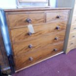 An early 19th century mahogany chest of two short over three long drawers, raised on bun feet, H.