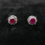 A boxed pair of 9ct yellow and white gold ruby and diamond cluster earrings. Cluster dia: 1cm.