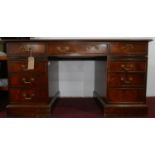 A Georgian style mahogany pedestal desk, with 2 brush slides and 8 drawers, H.77 W.145 D.75cm