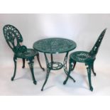 A green painted cast aluminium garden table and two chairs