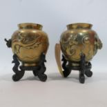 A pair of late 19th/early 20th century Chinese heavy brass vases, decorated with dragons and bearing