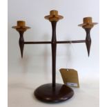A mid-century three branch candle holder from turned lignum vitae and with copper sconces H: 28cm,