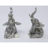 A pair of 800 silver novelty condiments in the form of seated elephants, both marked 800 to base.