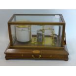 An Edwardian barograph in inlaid mahogany and glass case, with drawer, H.22 W.36 D.21cm