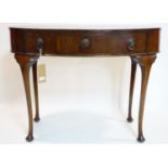 An early 20th century mahogany oval side table, with three drawers raised on cabriole legs, H.77 W.