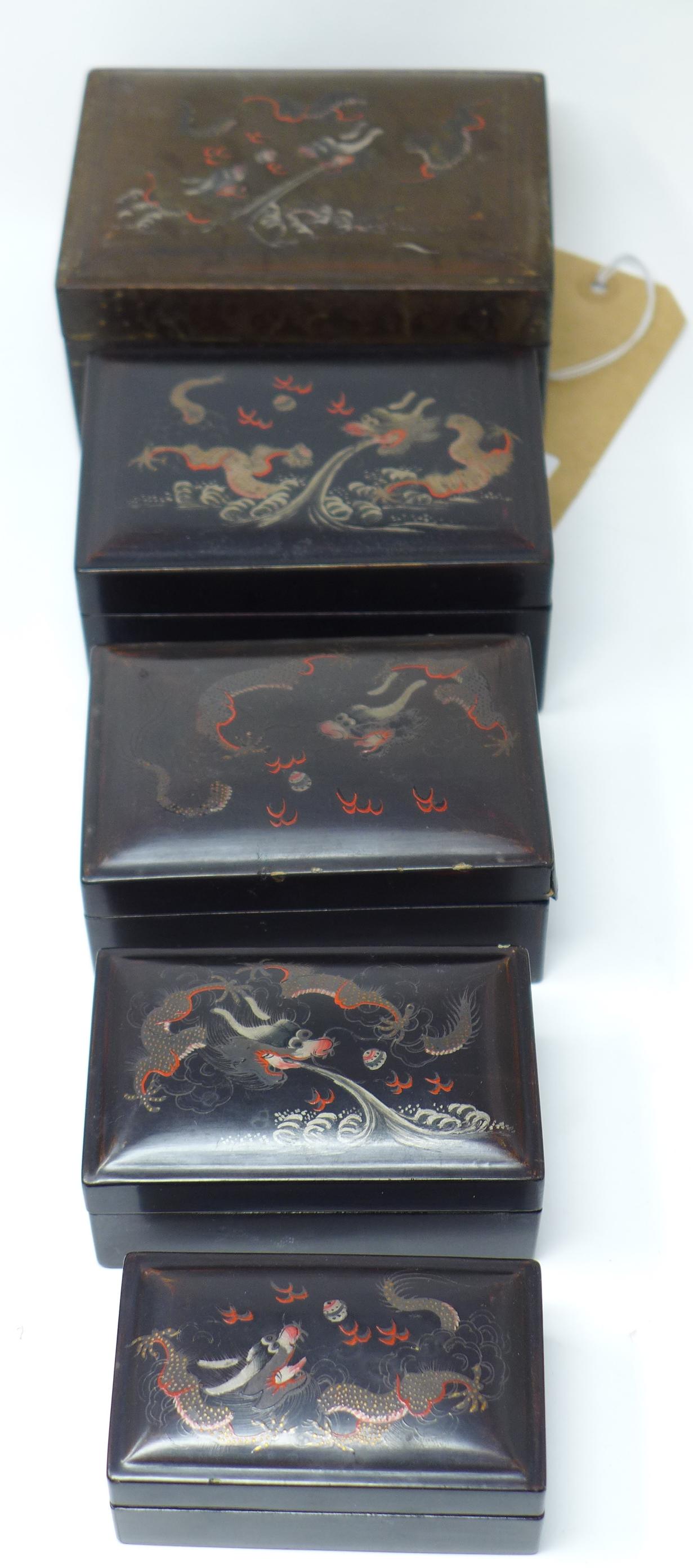 An early 20th century Chinese lacquered nest of five boxes decorated with dragons, H.8 W.14 D.10cm