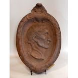 A stone plaque with portrait of a Greek figure, 66 x 43cm