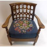 A Gothic style oak chair with tapestry upholstered seat