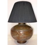 An early 20th century copper vase converted to a lamp