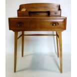 A mid 20th century Ercol elm desk, H.95 W.68 D.46cm