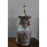 A late 19th century famille rose baluster vase converted to a lamp, decorated with vignettes of