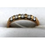 A 9ct yellow gold ring set with five diamonds, 0.33 carats, 2.2 grams