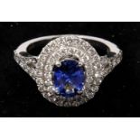 A boxed, 18ct white gold diamond and tanzanite cluster ring (2 carats approx)